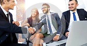 Handshake Manager and the client at a meeting in the office lobby.