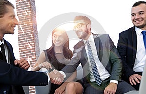 Handshake Manager and the client at a meeting in the office lobby.