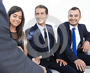 Handshake Manager and the client at a meeting in the office lobby.