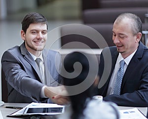 Handshake Manager and customer in a modern office.