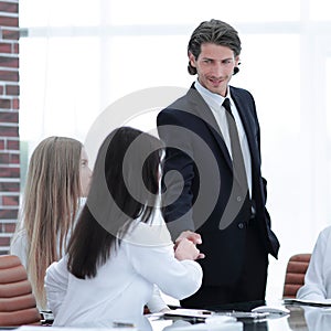 Handshake Manager and customer in a modern office