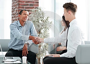Handshake Manager and customer in a modern office