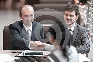Handshake Manager and customer in a modern office.