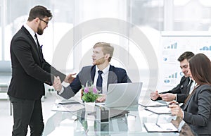 Handshake Manager and employee in the workplace