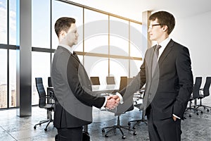 Handshake in modern conference room