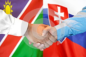 Handshake on Namibia and Slovakia flag background