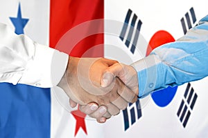 Handshake on Panama and South Korea flag background