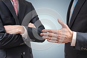 Handshake refuse. Man is refusing shake hand with businessman who is offering his hand