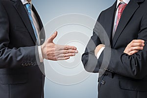 Handshake refuse. Man is refusing shake hand with businessman who is offering his hand.