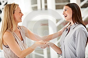 Handshake, smile and partnership with business women in the office for b2b deal or agreement. Welcome, thank you or