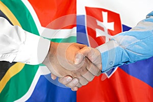 Handshake on South Africa and Slovakia flag background