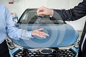 Handshake after success deal sale purchase between customer and dealer at showroom.