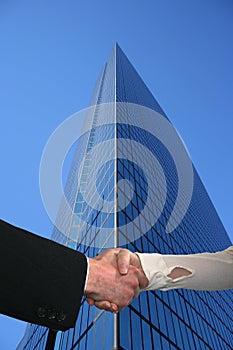 Handshake with tall skyscraper