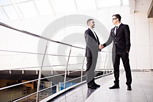 Handshake of two business men closing a deal at the office