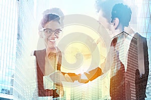 Handshake of two businessperson in office concept of partnership and teamwork.double exposure