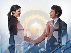 Handshake of two businessperson in office concept of partnership and teamwork.double exposure