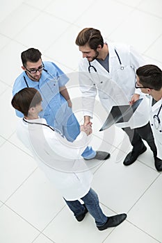 Handshake two doctors at the meeting.