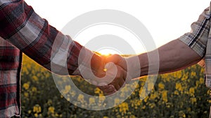 Handshake Of Two Farmers Businessmen In A Rural Field At Sunset