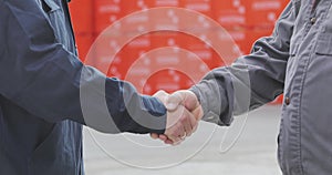 Handshake of two men close-up. Two men shake hands. Factory shaking hands, concluding a successful deal