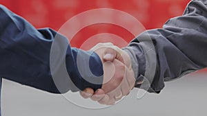 Handshake of two men close-up. Two men shake hands. Factory shaking hands, concluding a successful deal