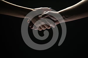 Handshake between the two partners. Rescue or helping gesture of hands. Concept of salvation. Hands of two people at the