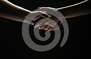 Handshake between the two partners. Rescue or helping gesture of hands. Concept of salvation. Hands of two people at the