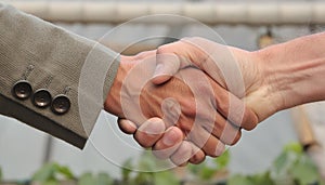 A handshake between two people at the blurred background