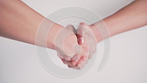 Handshake of two young people on a white background