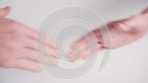 Handshake of two young people on a white background