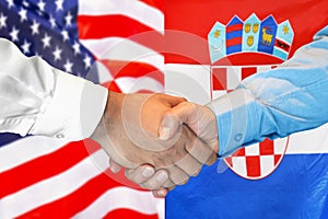 Handshake on US and flag of Croatia background. Support concept in Republic of Croatia