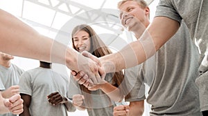 Handshake of young people in a circle of friends