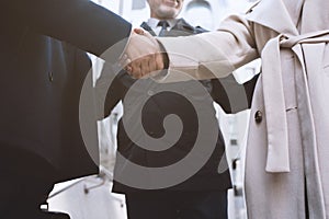Handshaking business person in office. concept of teamwork and partnership.