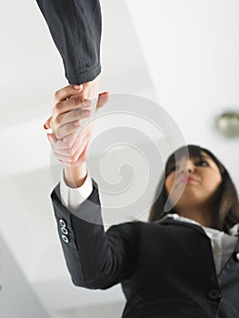 Handshaking in office low angle