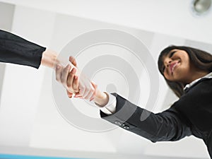 Handshaking in office low angle