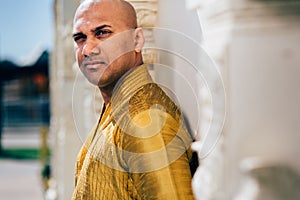 Handsom Indian Man in Gold Kurta at the Temple
