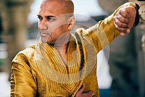 Handsom Indian Man in Gold Kurta at the Temple