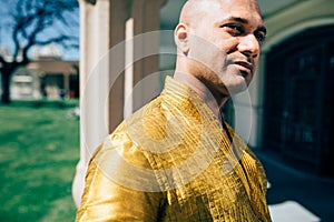 Handsom Indian Man in Gold Kurta at the Temple