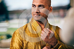 Handsom Indian Man in Gold Kurta at the Temple