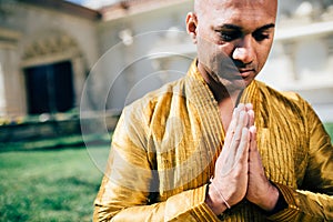 Handsom Indian Man Greeting Namaste in Gold Kurta at the Temple