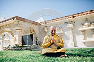 Handsom Indian Man Greeting Namaste in Gold Kurta at the Temple