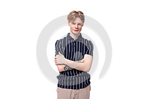 handsome 25s blond man dressed in a tank top with tattoos posing on a white background