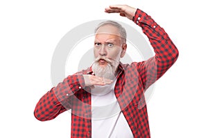 handsome 60s retired man with white beard and mustache making a face