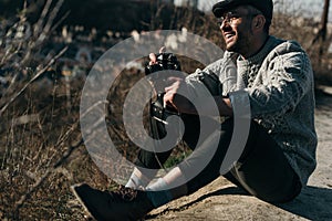 handsome adult man with vintage film camera sitting