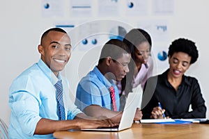 Handsome african american businessman with business team at office