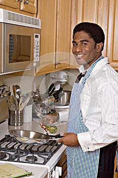 Handsome African-American businessman in kitchen