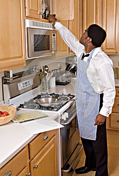 Handsome African-American businessman in kitchen