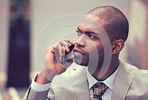 Handsome african american businessman talking on mobile phone