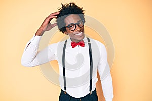 Handsome african american man with afro hair wearing hipster elegant look confuse and wonder about question