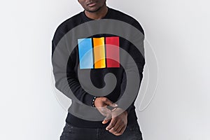 Handsome African American man posing in black sweatshirt on a white background, close-up. Youth street fashion photo