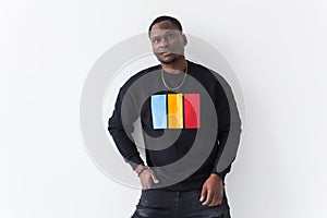 Handsome African American man posing in black sweatshirt on a white background. Youth street fashion photo with afro